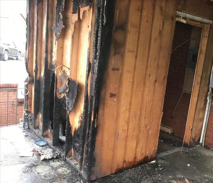 Charred wood on a porch from a fire