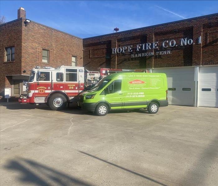SERVPRO van and fire truck in front of fire station