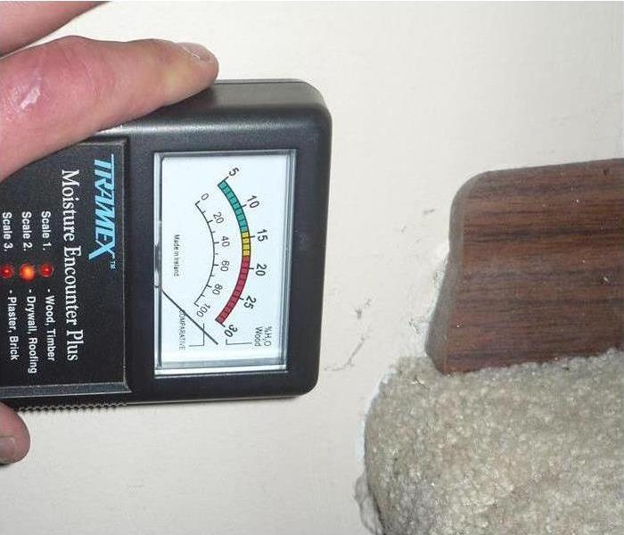 Moisture meter against a wall