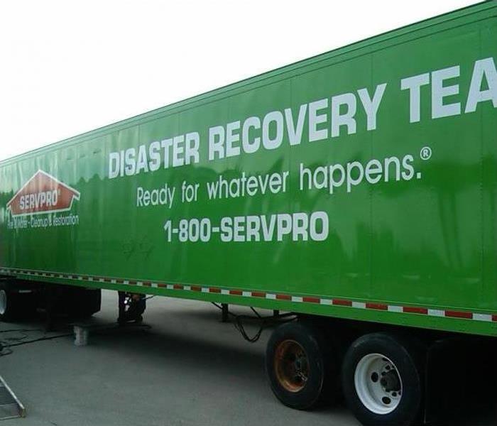 SERVPRO tractor trailer parked in front of a city building